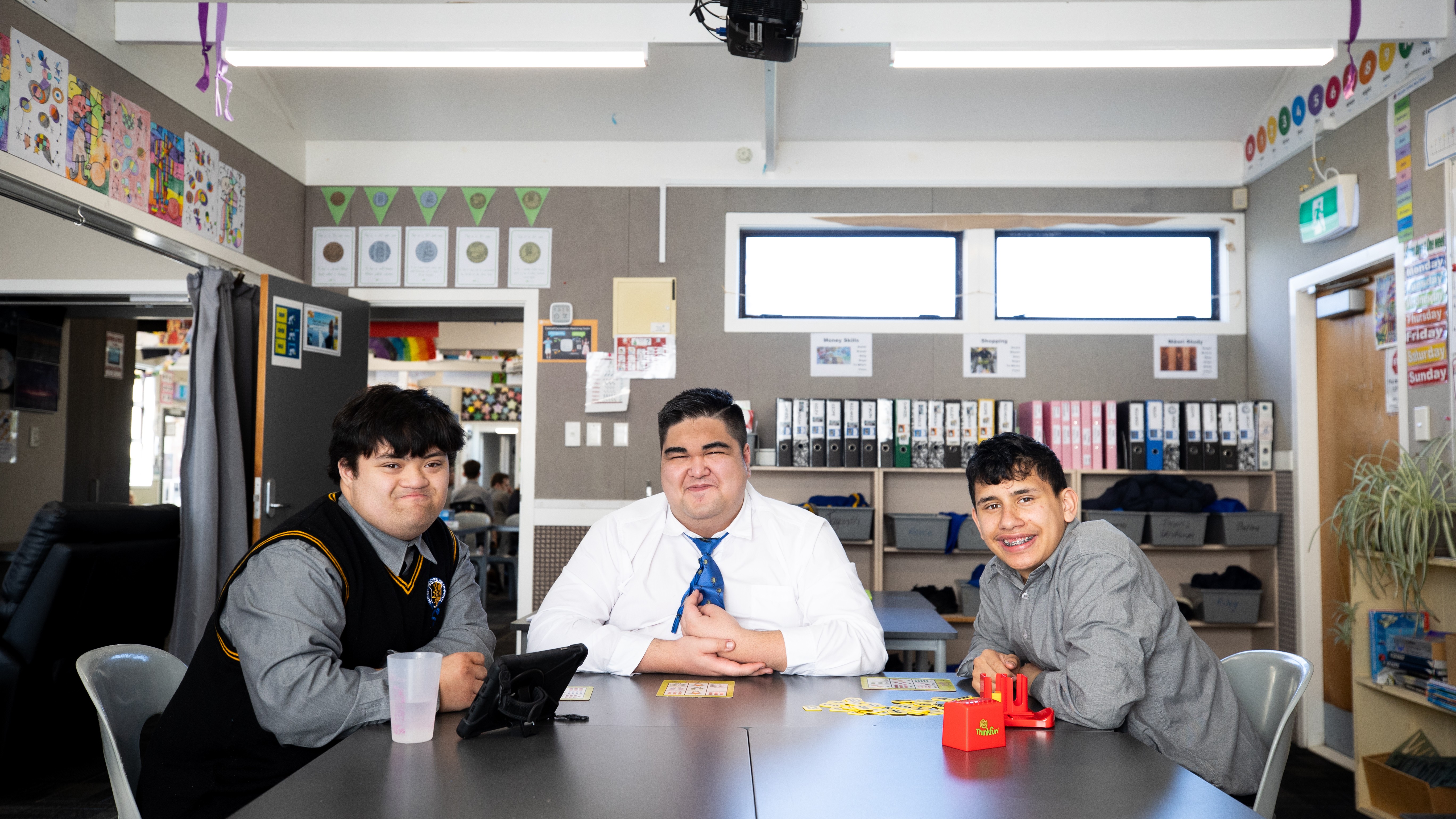 3 teenage boys in a college classroom