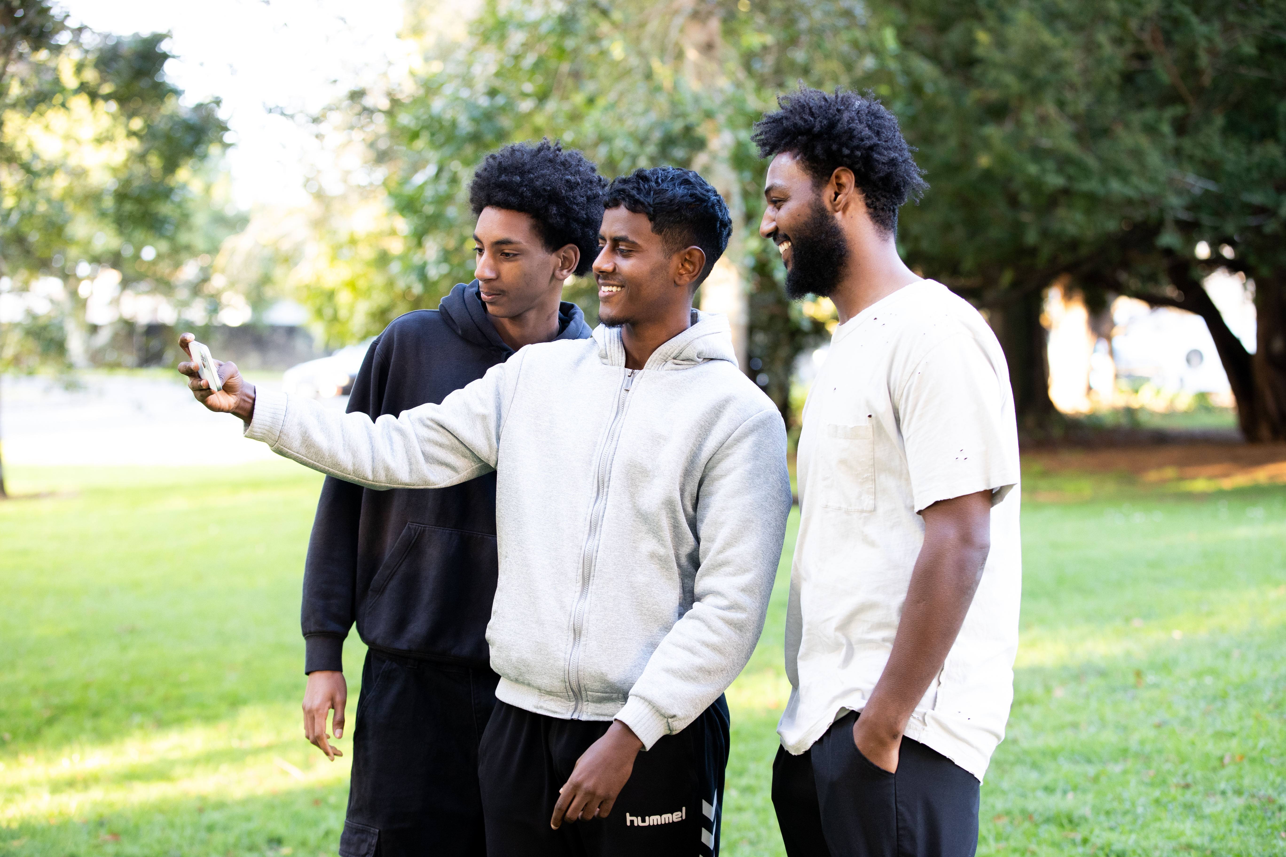Ethnic males at a football game taking a selfie
