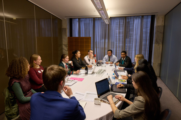 Young people from the Philanthropic Giving group are pictured seated at a round table mid-discussion