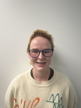 Grace Foster smiles against a plain white backgrop