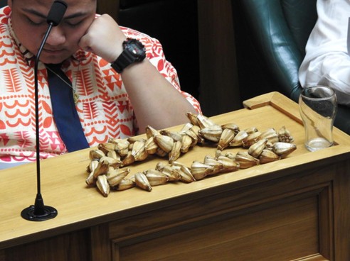 A close up shot of an ulafala lays on a desk in the Debate Chamber