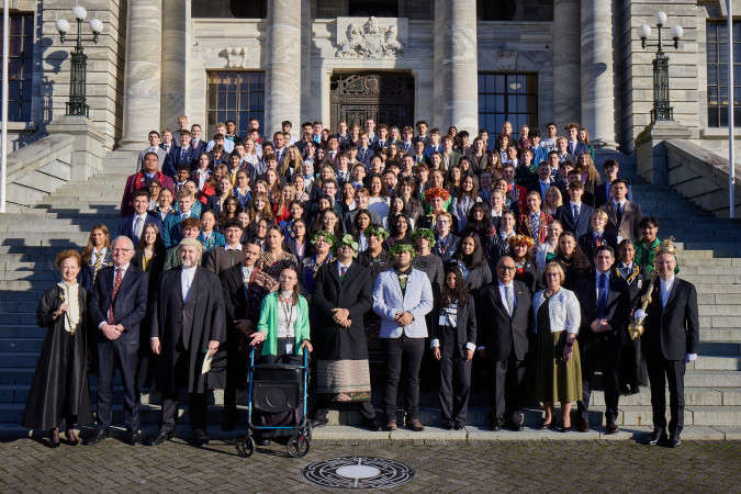 Photo of Youth MPs standing on the front steps of Parliament